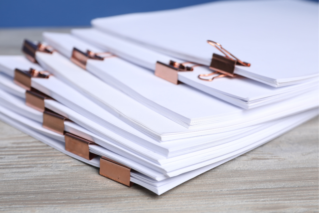 Stack of organized documents with copper clips, representing the paperwork needed to be an advocate for your child in education and special services.