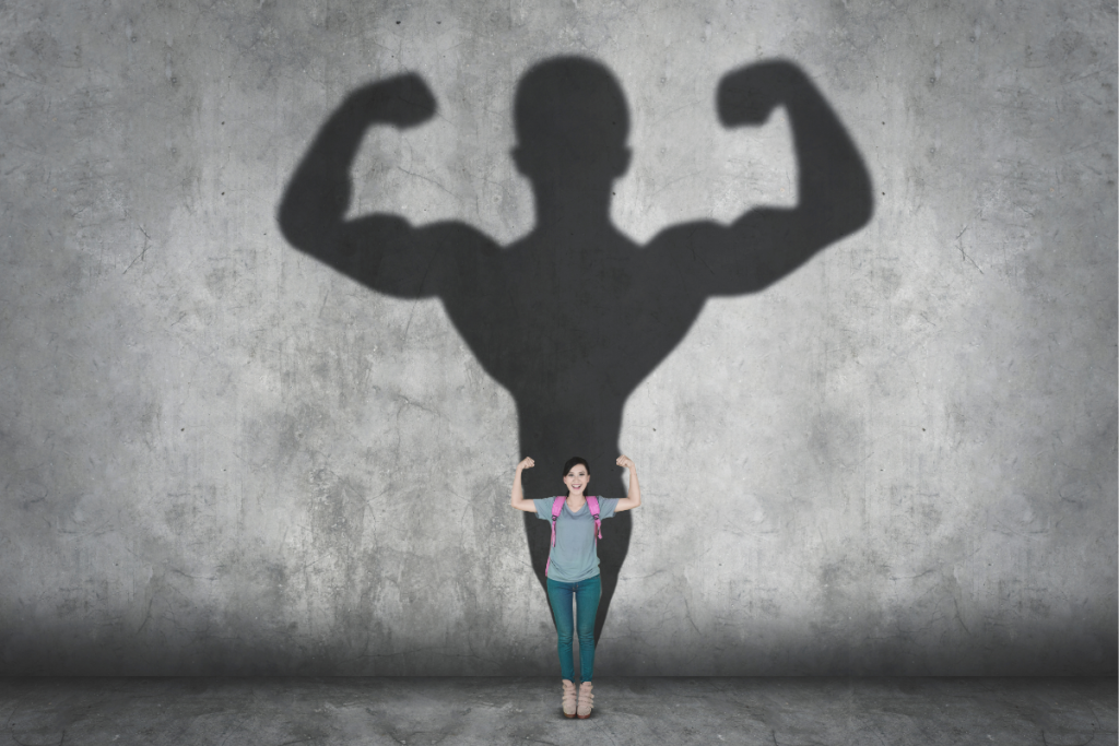 Young girl standing confidently with strong shadow behind her, symbolizing the strength it takes to be an advocate for your child.