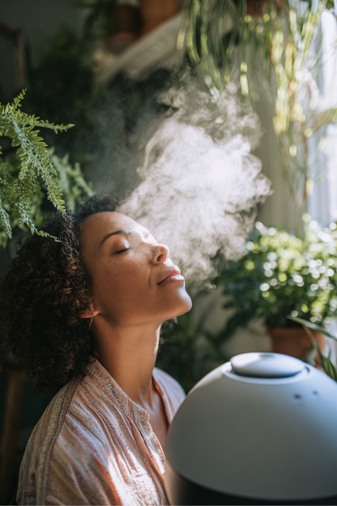 A woman relaxes with her eyes closed as steam drifts across her face, modeling the self-care mamas need because advocacy isn’t optional.