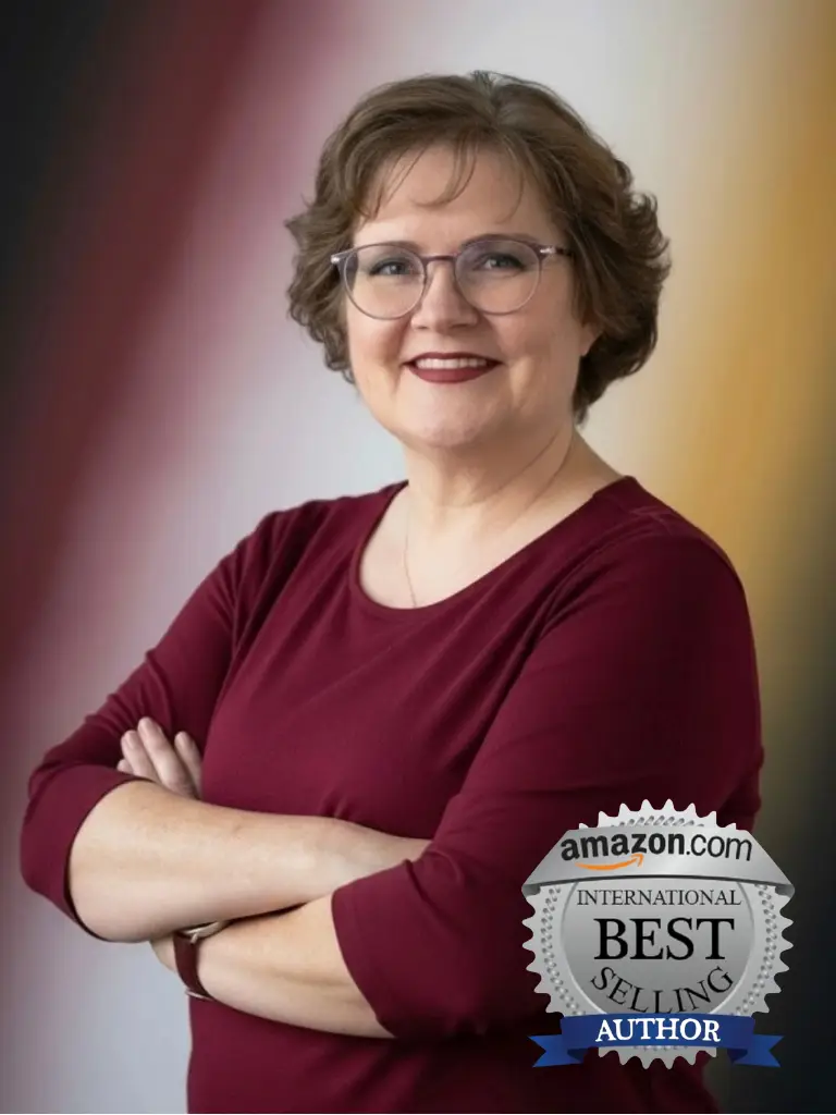 Portrait of Vanessa Moyers, international best-selling author, smiling confidently with arms crossed in a burgundy top, standing in front of a soft gradient background. An Amazon “International Best-Selling Author” badge is displayed on the lower right to highlight her author status.