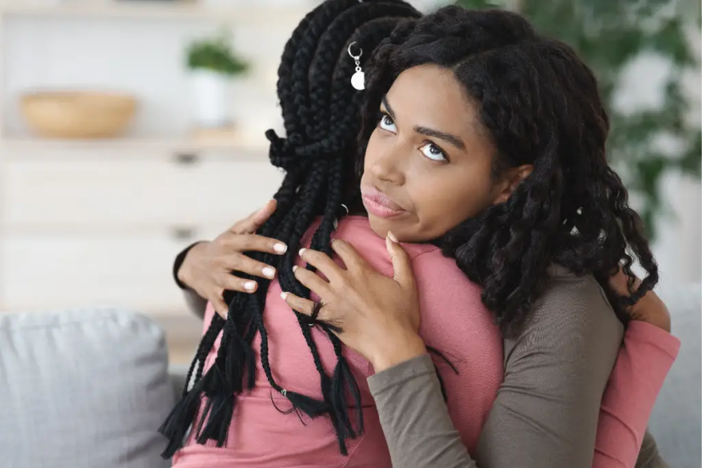 Parent holding her child in a moment of connection, illustrating AuDHD parenting and the lived experience of autism and ADHD overlap.