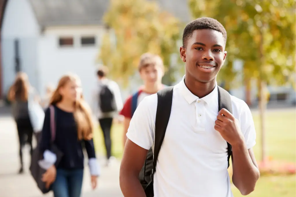 Teen appearing confident at school while navigating invisible challenges, reflecting AuDHD parenting beyond surface-level functioning.