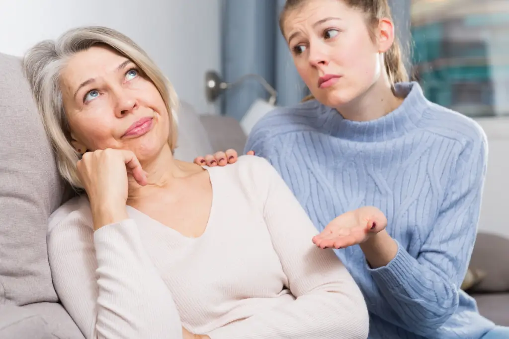 Mother listening with concern as her adult daughter explains something, illustrating adult ADHD impulse control at home and family boundary conversations.